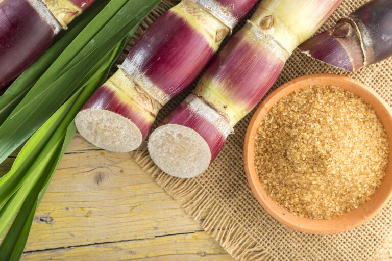 Brown sugar and cane on the table top view, image